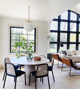 Interior of modern home featuring large windows with black frames.